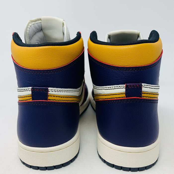 A brand new Jordan 1 High SB LA to Chi sneaker rests on a black Jordan box with a red logo. This authentic high-top shoe features multi-colored accents of purple, yellow, white, and red, with the label proudly reading 1985 Air Jordan 1.