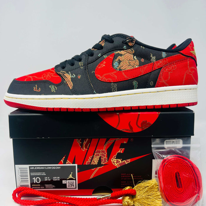Jordan 1 Low OG Chinese New Year sneaker in black and red with dragon design, extra laces and tassels, displayed on Nike box.