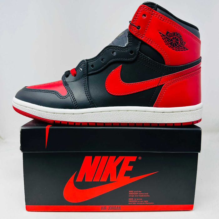 Jordan 1 Retro High '85 OG Bred (2025) sneaker with red and black colorway, includes red laces and hang tag, brand new condition on Nike box.
