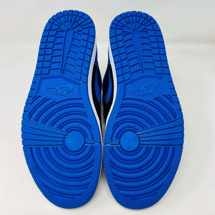 A pair of new Jordan 1 Retro High OG Royal Reimagined sneakers by Jordan rests on a matching box. These genuine shoes have blue accents on the swoosh, heel, and toe cap with a white midsole. The box also features a blue Nike logo.