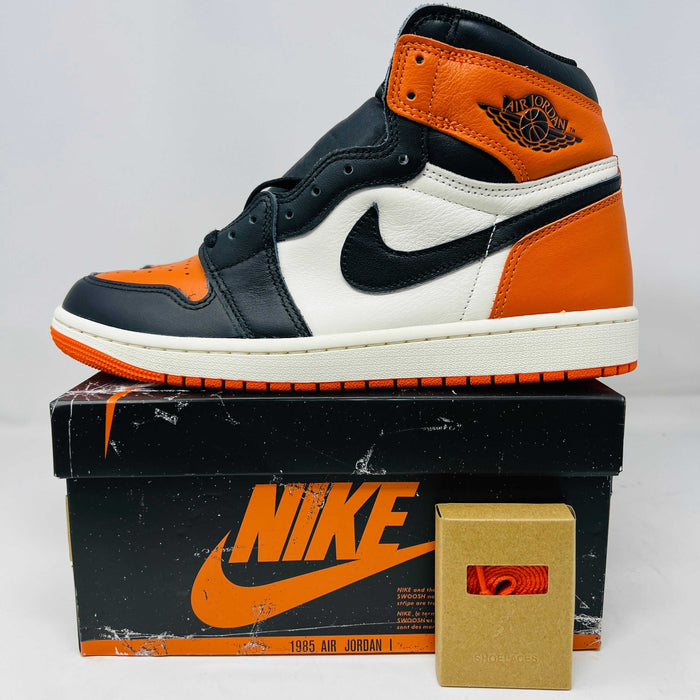 Jordan 1 Retro High OG Shattered Backboard sneaker in black and orange on Nike box with extra laces 2025 edition