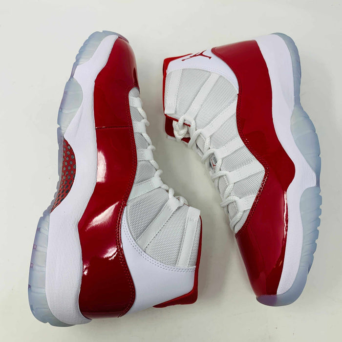 Jordan 11 Retro Cherry 2022 sneakers in white and red with leather and mesh upper, patent leather accents, and full-length Air-Sole unit.
