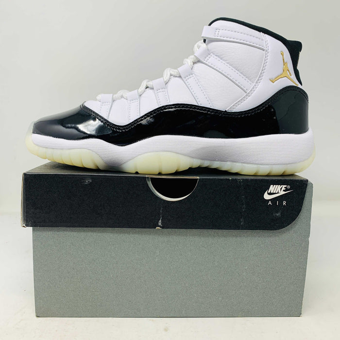 Jordan 11 Retro DMP Gratitude 2023 GS sneakers in black and white on shoe box.
