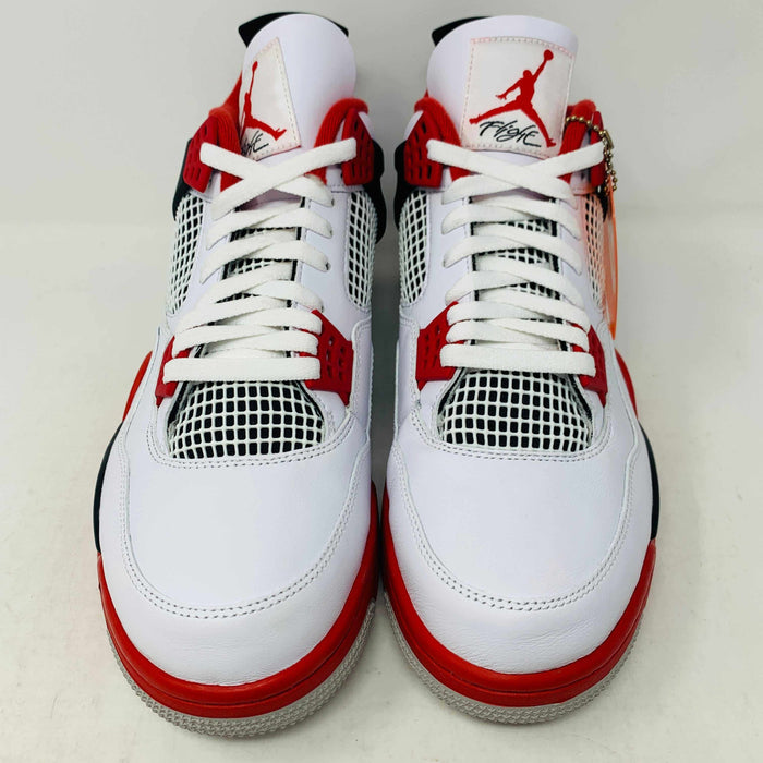 The Jordan 4 Fire Red sneaker in white, red, and black is brand new and authentic, featuring mesh details, a visible air unit in the sole, and a Nike Air tag on the laces. It comes in a box with a speckled gray design and red Nike Air logo.