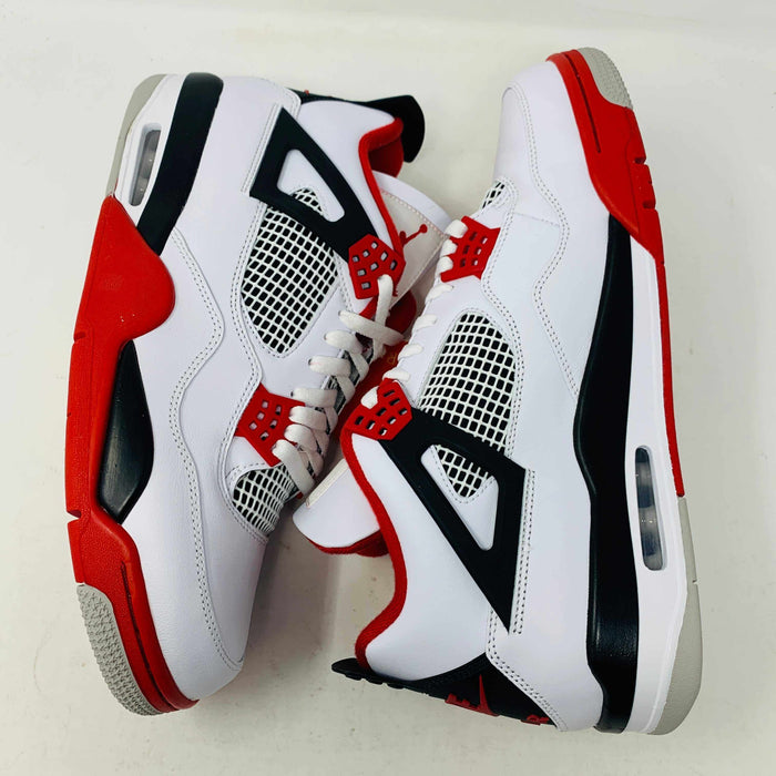 The Jordan 4 Fire Red sneaker in white, red, and black is brand new and authentic, featuring mesh details, a visible air unit in the sole, and a Nike Air tag on the laces. It comes in a box with a speckled gray design and red Nike Air logo.