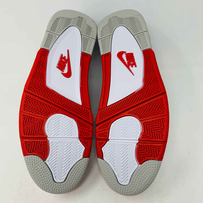 The Jordan 4 Fire Red sneaker in white, red, and black is brand new and authentic, featuring mesh details, a visible air unit in the sole, and a Nike Air tag on the laces. It comes in a box with a speckled gray design and red Nike Air logo.