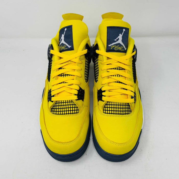 Jordan 4 Lightning sneakers with bold yellow and black colorway.