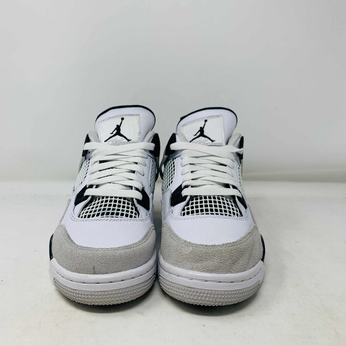 The Jordan 4 Military Black GS sneakers, featuring distinctive side netting and a logo on the tongue, are brand new and authentic in white and gray with black accents. They face forward on a white surface against a plain background, embodying modern style.