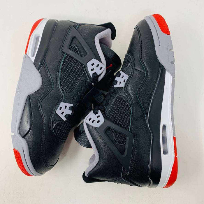 Jordan 4 Retro Bred Reimagined (GS) sneakers, black and red, leather and mesh upper, Jumpman logo, Air-Sole cushioning.