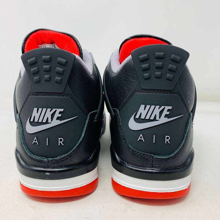 Jordan 4 Retro Bred Reimagined GS sneakers in black and red with Nike Air branding on the heel.