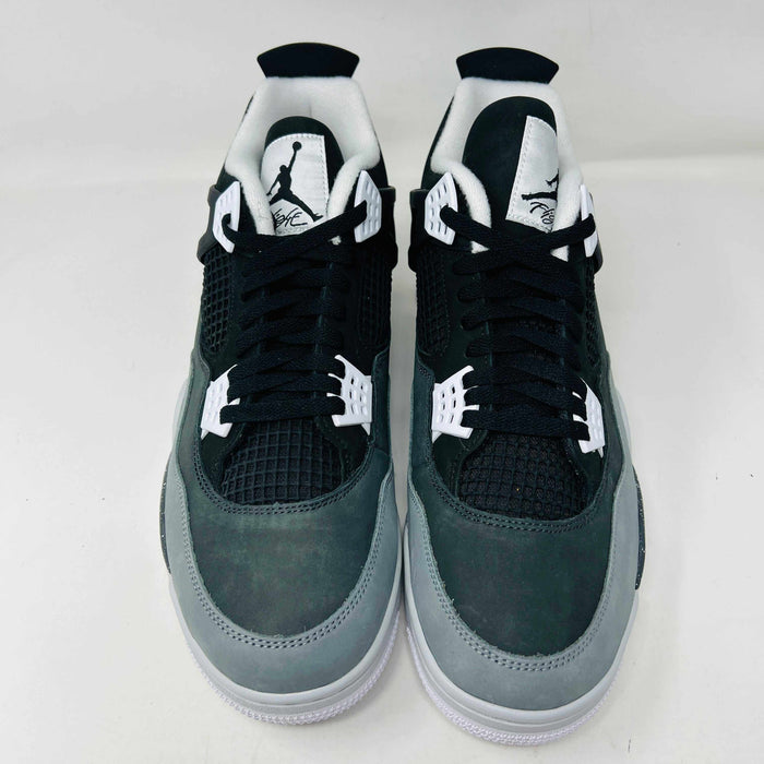 On top of a shoebox sits the brand-new Jordan 4 Retro Fear (2024), a stylish sneaker by Jordan. Its black and gray color scheme, black mesh accents, white midsole, and speckled heel details make it a must-have for 2024.