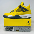 Jordan 4 Retro Lightning 2021 yellow and black sneaker on matching box with air cushioning and classic design