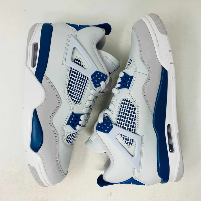 The Jordan 4 Retro Military Blue (2024) sneaker, with white and blue mesh details and a visible air cushion, rests on a black speckled NIKE AIR box with bold orange text. It is 100% authentic, including orange tags, ensuring it’s brand new.