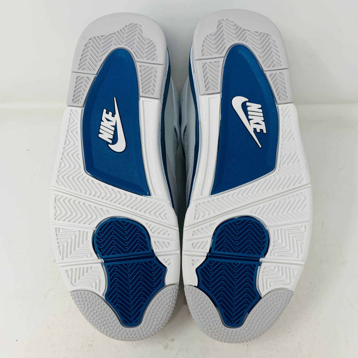 The Jordan 4 Retro Military Blue (2024) sneaker, with white and blue mesh details and a visible air cushion, rests on a black speckled NIKE AIR box with bold orange text. It is 100% authentic, including orange tags, ensuring it’s brand new.