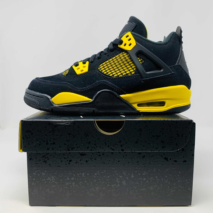 Jordan 4 Retro Thunder 2023 GS sneakers, black and yellow, brand new condition.