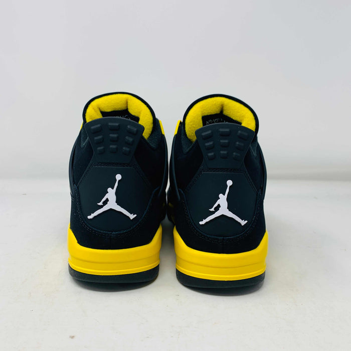 Jordan 4 Thunder 2023 brand new sneakers with black and yellow design.