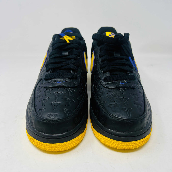 Brand new Nike Air Force 1 Low Kobe Bryant Lakers Away sneaker in black with yellow and blue accents, featuring embossed details. Displayed on a white box with a yellow Nike logo and Kobe Bryant symbol. Limited edition of 8000, ideal for those seeking standout accessories.