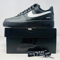 Nike Air Force 1 Low Supreme Black White sneaker on box with extra Supreme laces