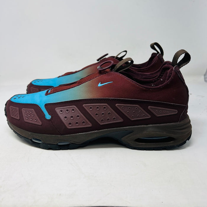 The Nike Air Max Sunder Burgundy Crush Baltic Blue (W) sneakers, released in 2024, feature a gradient design from blue to burgundy with a geometric side pattern and small blue swoosh, displayed against a white background with light wear.