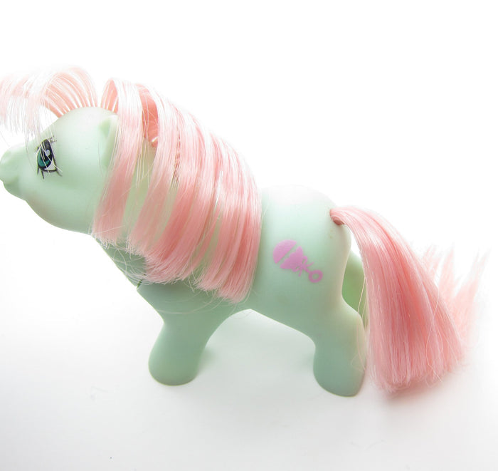 Baby Cuddles pony with pink rattle symbol