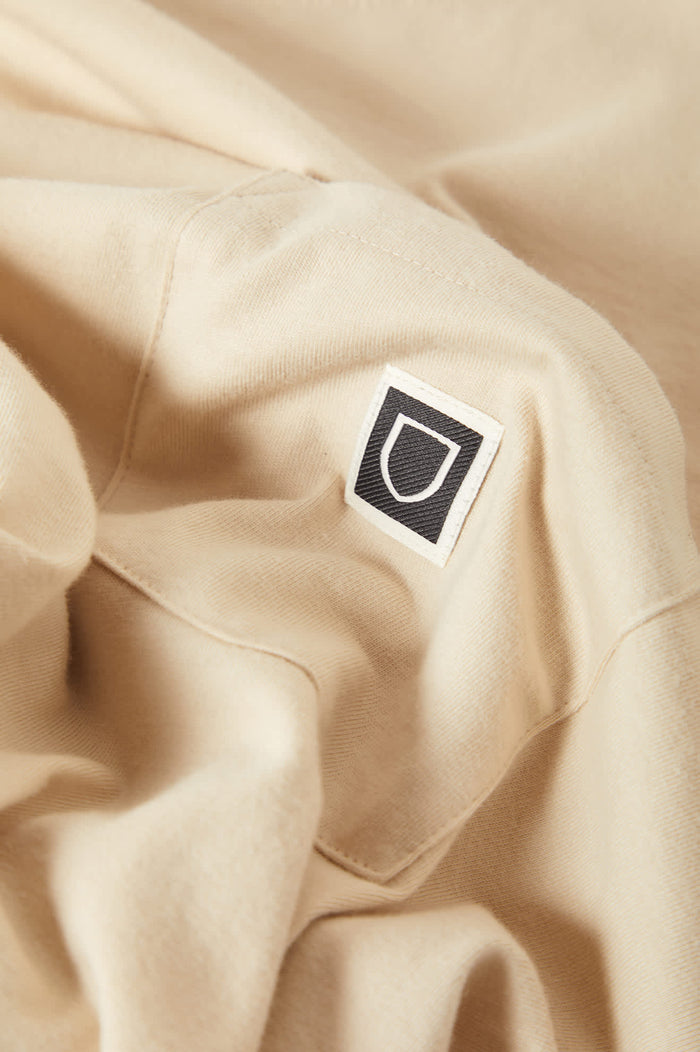 Men's Beta Sheild Short Sleeve Pocket T-Shirt in the color Cream - Additional Laydown image
