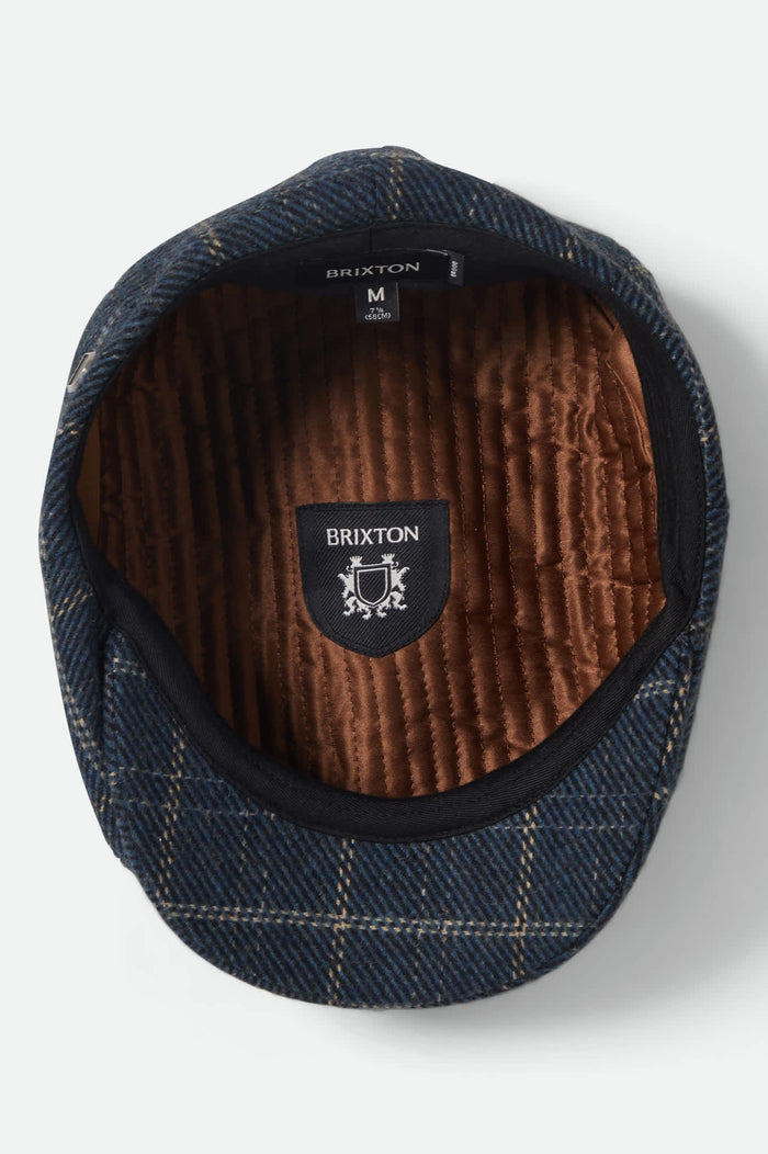 Unisex Brood Newsboy Cap in the color Mood Indigo/Tan - Additional Laydown image