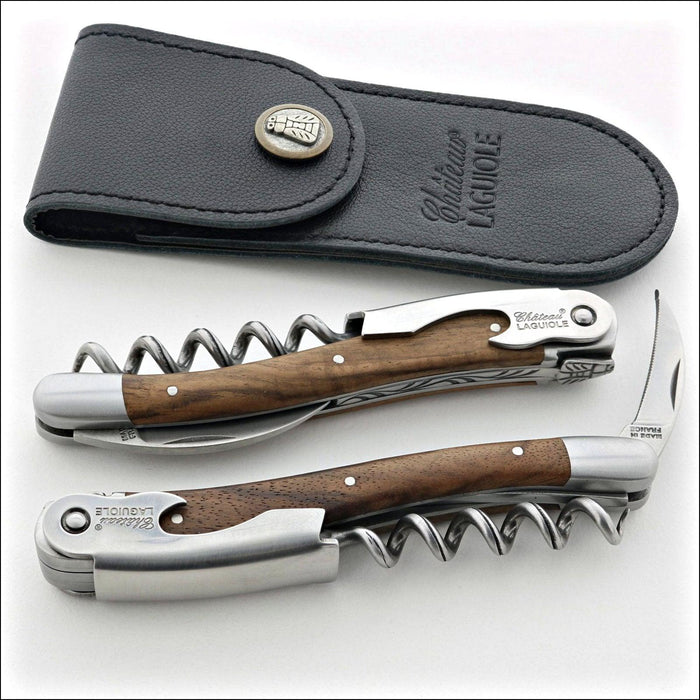 Chateau Laguiole Classic Walnut Corkscrew, top-down view of two corkscrews and a black leather pouch. Handcrafted details, 100% Made in France.