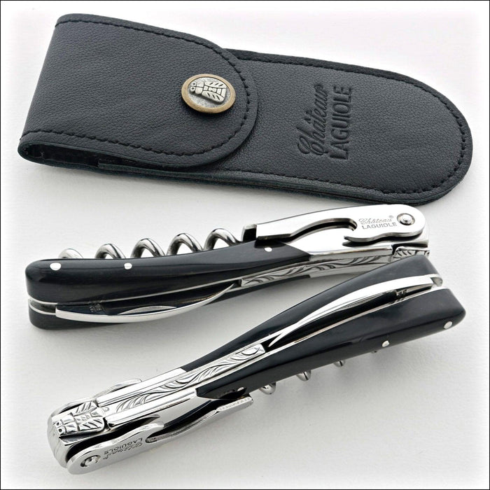 Chateau Laguiole Melchior Dark Horn Tip Handle, close-up of two corkscrews with black leather sheath. Handcrafted details, 100% Made in France.