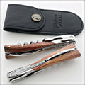 Chateau Laguiole Melchior Rosewood Handle corkscrew, top-down view with black leather case. Handcrafted details, 100% Made in France.