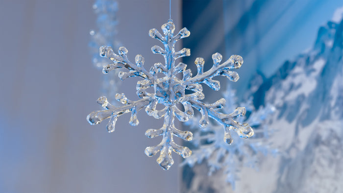 Crystal snowflake ornament against a snowy landscape