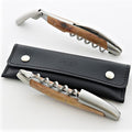 Forge de Laguiole corkscrew with vine wood handle and satin steel, shown with black leather case.
