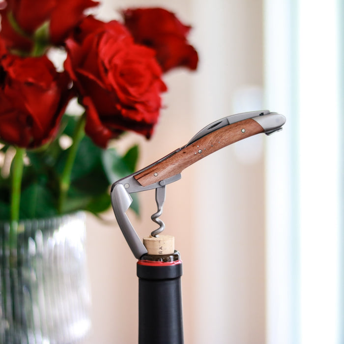 Forge de Laguiole Corkscrew, side view of vine wood handle and satin steel in a wine bottle cork.