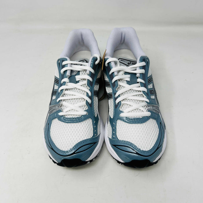 The ASICS Gel-Kayano 14 White Fjord Grey running shoe stands on a brown ASICS box, featuring intricate designs, a breathable mesh upper, and a cushioned thick sole for support. Its 100% authentic.