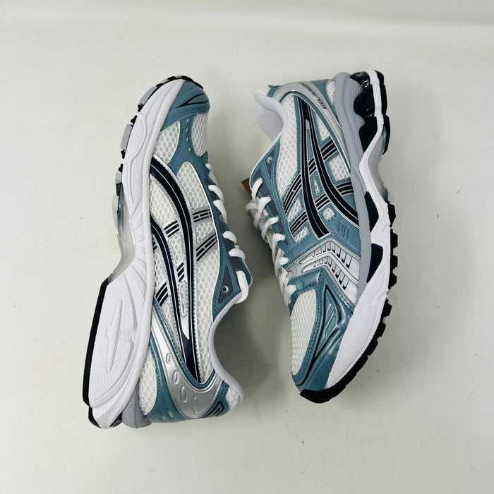 The ASICS Gel-Kayano 14 White Fjord Grey running shoe stands on a brown ASICS box, featuring intricate designs, a breathable mesh upper, and a cushioned thick sole for support. Its 100% authentic.