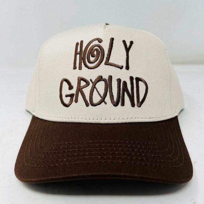 The Holy Ground Stussy Hat by Holy Ground is a streetwear accessory with HOLY GROUND embroidered in black on its white front panel, complemented by a green bill for a fresh touch.