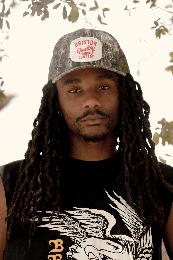 Unisex Hubal Netplus Trucker Hat in the color Tree Camo/Olive - Men's Lifestyle 3.0