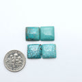 Hubei Cloud Mountain Turquoise cabochons, blue and green color with black matrix, polished stones on a white background with a US dime for scale