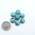 Hubei Cloud Mountain Turquoise cabochons, blue and green color with black matrix, polished stones on a white background, with a US dime for scale