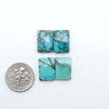 Hubei Cloud Mountain Turquoise cabochons, blue and green color with black matrix, polished stones on a white background with a US dime for scale