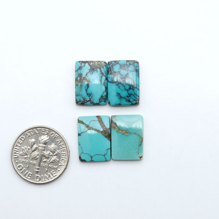 Hubei Cloud Mountain Turquoise cabochons, blue and green color with black matrix, polished stones on a white background with a US dime for scale