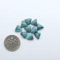 Hubei Cloud Mountain Turquoise cabochons, blue and green color with black matrix, polished stones on a white background with a US dime for scale