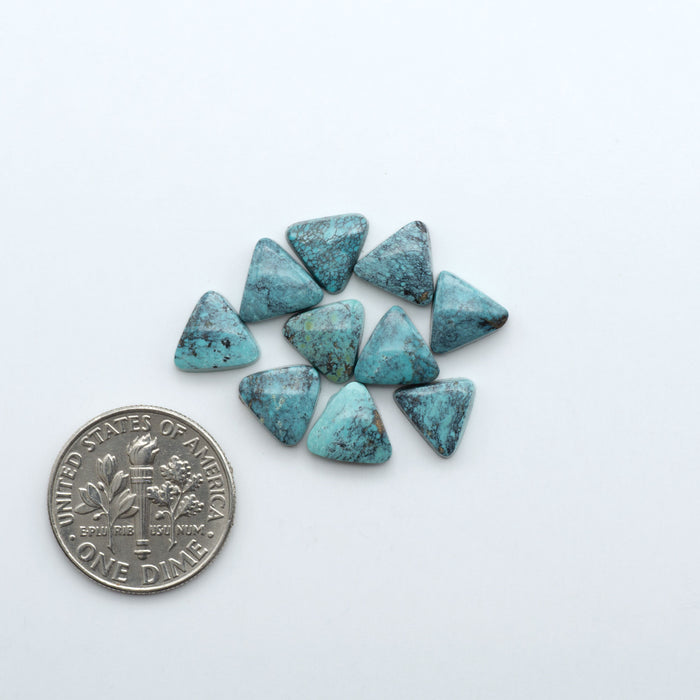 Hubei Cloud Mountain Turquoise cabochons, blue and green color with black matrix, polished stones on a white background with a US dime for scale