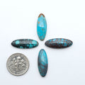 Hubei Cloud Mountain Turquoise cabochons, blue and green color with black matrix, polished stones on a white background with a US dime for scale