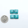 Hubei Cloud Mountain Turquoise cabochons, blue and green color with black matrix, polished stones on a white background with a US dime for scale