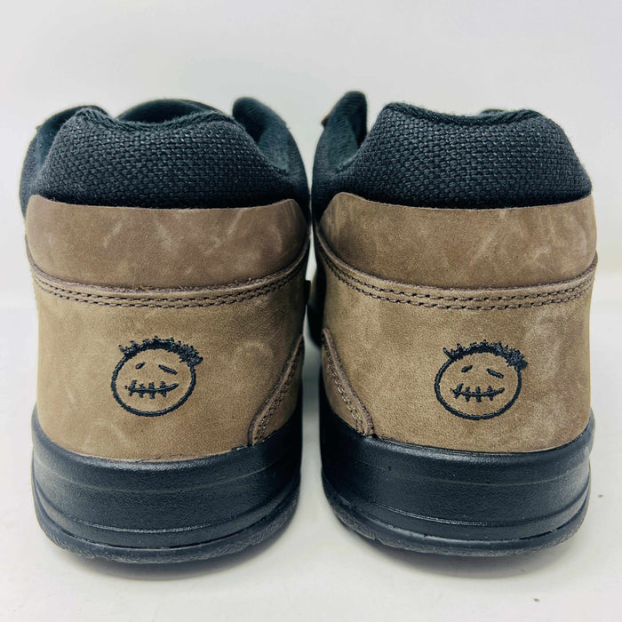 A pair of Jordan Jumpman Jack TR Travis Scott Dark Mocha sneakers are showcased on a brown box labeled JACK in white. The brown and black sneaker features a black swoosh, laces, and textured sole. Its 100% authentic with extra laces and bag, set against a plain white background.