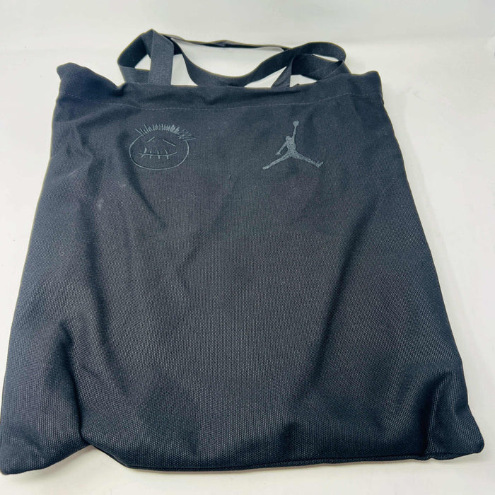 A pair of Jordan Jumpman Jack TR Travis Scott Dark Mocha sneakers are showcased on a brown box labeled JACK in white. The brown and black sneaker features a black swoosh, laces, and textured sole. Its 100% authentic with extra laces and bag, set against a plain white background.