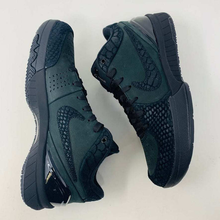 A brand new Nike Kobe 4 Protro Gift of Mamba sneaker in black, featuring a textured design with glossy and matte elements and prominent swoosh logo, is showcased atop its matching shoebox. Distinct patterns on the side and heel capture the essence of 2023s authentic shoe style.