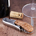 Laguiole Magnum Burled Teak Corkscrew close-up featuring a polished steel body and wood grain handle.
