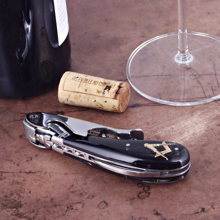 Laguiole Magnum Masonic Symbol Inlay Corkscrew, black handle with gold Masonic symbol, close-up.
