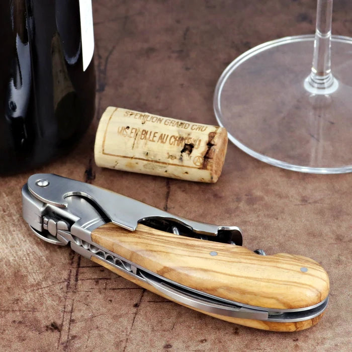 Laguiole Magnum Olive Wood Corkscrew, close-up side view showing polished steel and wood grain handle.